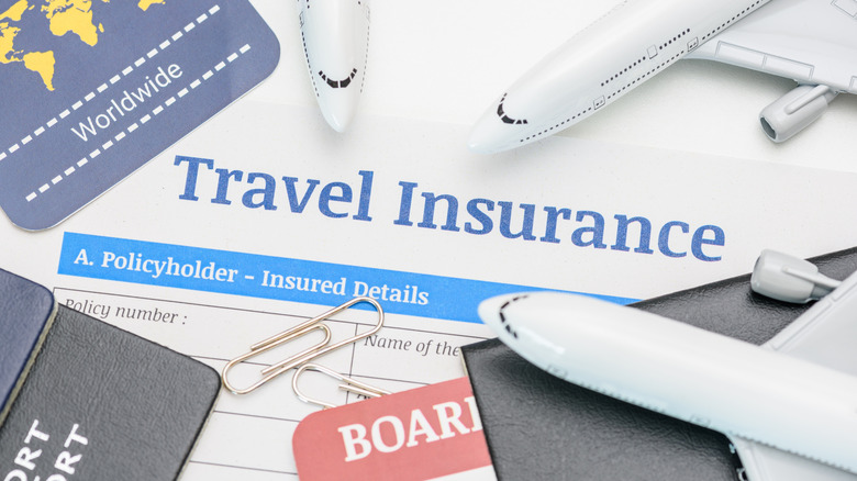 travel insurance paper and airplane figurines