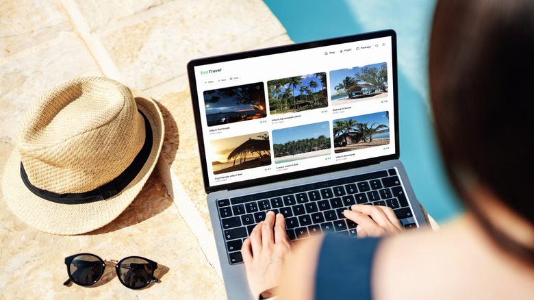 woman searching for resorts on laptop