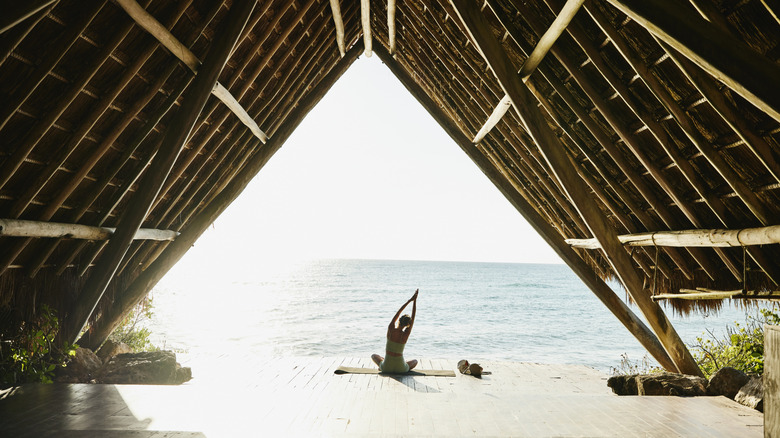 woman doing yoga at exclusive beach area