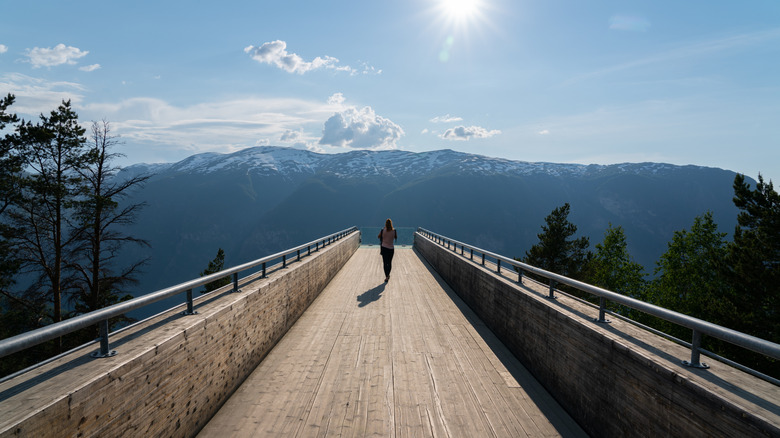 A woman on a boardwalk at the Stegastein Viewpoint, Norway.