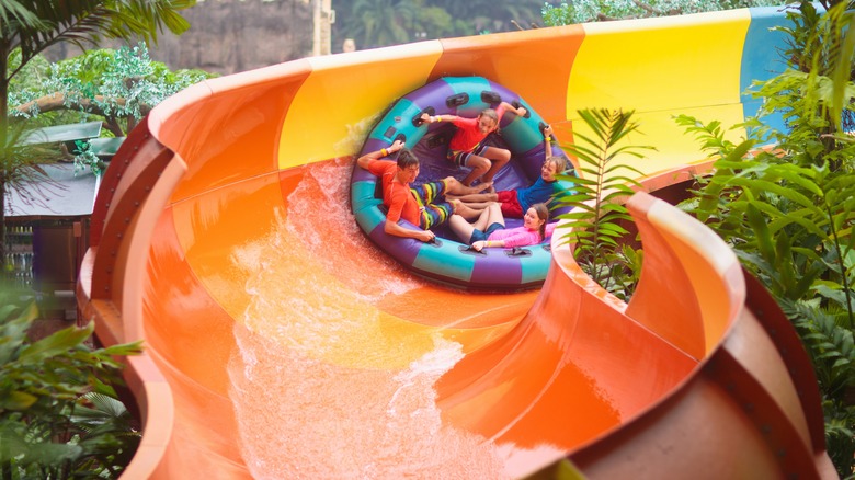 kids on a water slide at a theme park