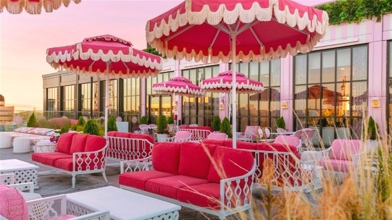 Rooftop bar with pink seating and pink umbrellas