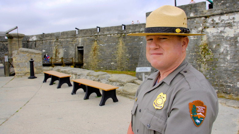 A U.S. national park ranger wearing a uniform and looking into the camera.