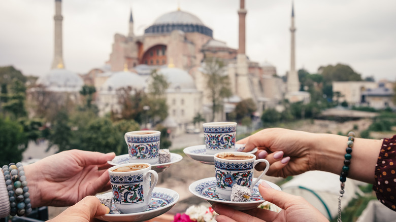 Four women enjoy coffee in front of the Hagia Sofia in Istanbul