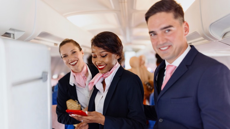 Three smiling flight attendants