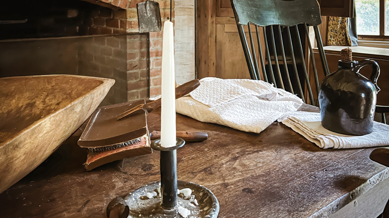 A 19th-century table with a candlestick and rocking chair