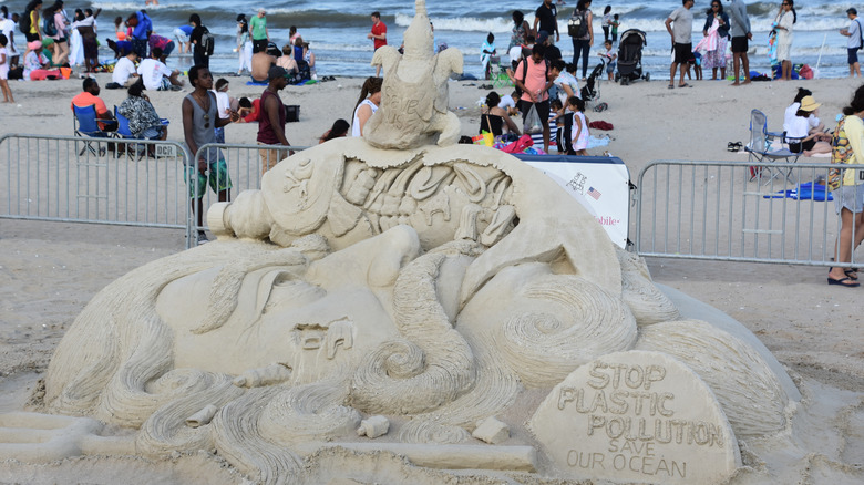 Sand sculpture on the beach, pedestrians