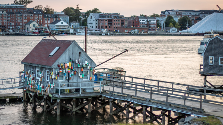 A fishing shack sits above the Piscataqua River