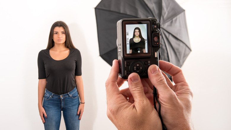 Woman having passport photo taken