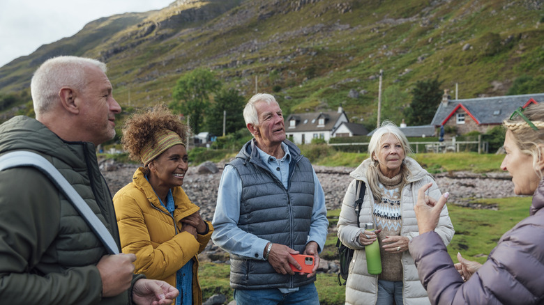 Four people talking in the Scottish countryside