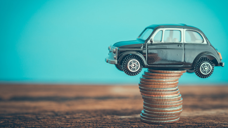 Miniature car balancing on coins