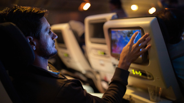 Man looking at a plane screen