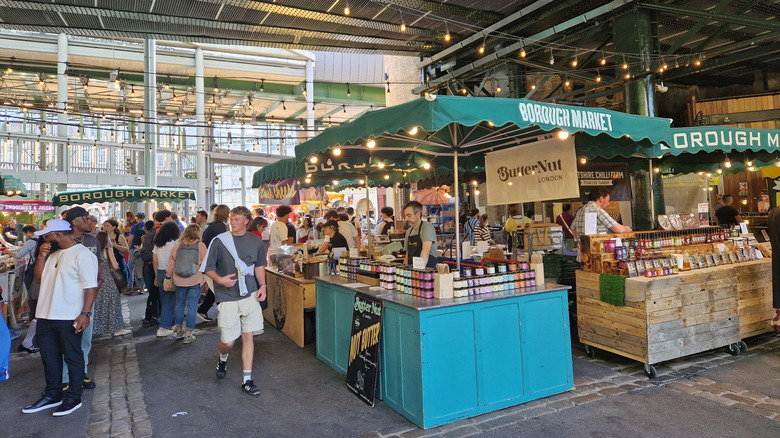 A large crowd of people browsing the stalls of Borough Market
