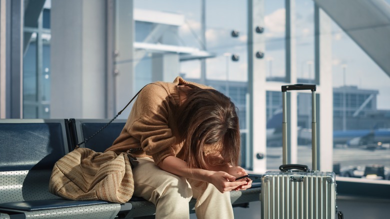 A tired woman waits for her flight