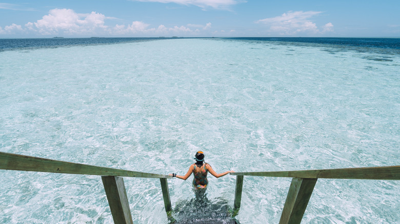 A woman walking in the ocean