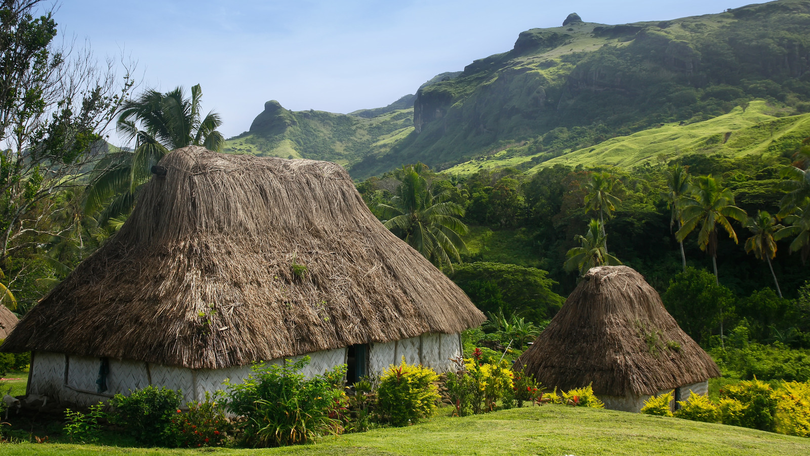 The Remote Fijian Village Surrounded By Lush Mountains And Traditional ...