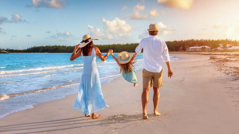 Family strolling on the beach on vacation