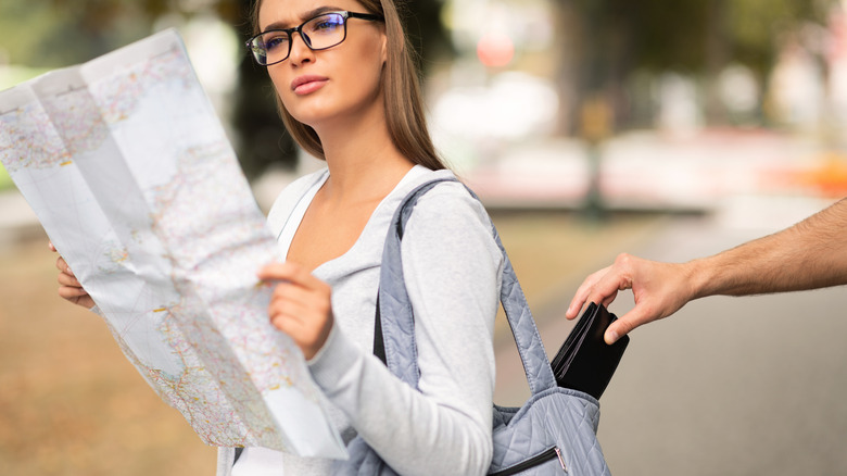 woman pickpocketed looking at map 
