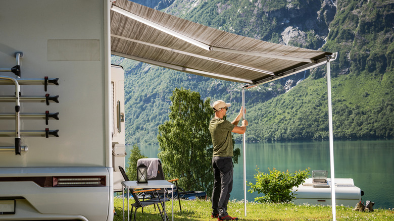 Man setting up RV outside