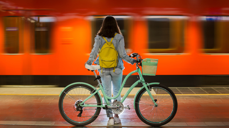 Girl with bicycle at subway
