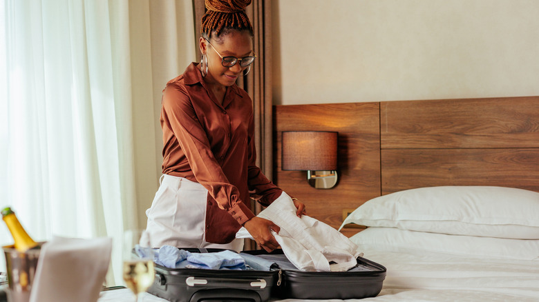 Woman unpacking in a hotel