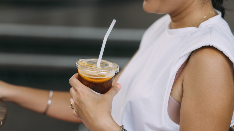 person drinking from straw