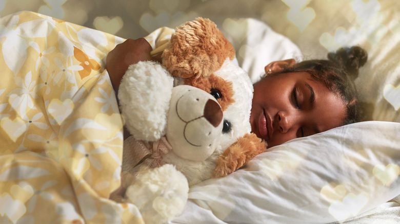 Girl sleeping with stuffed animal