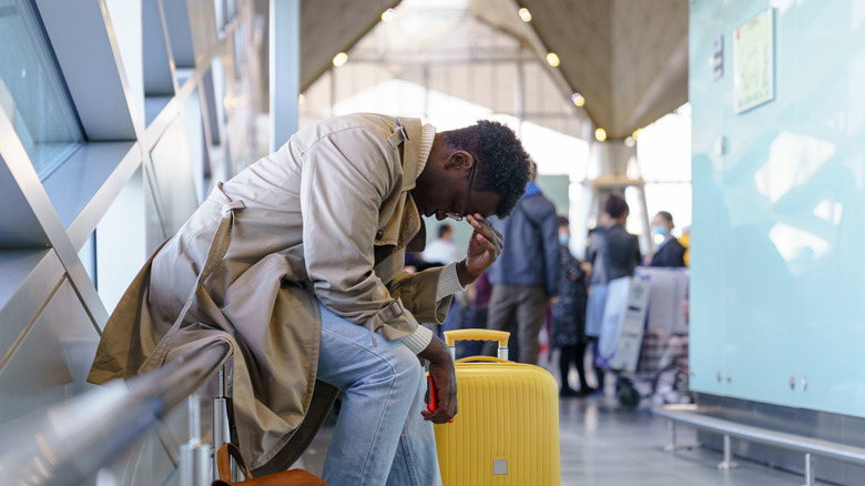 Upset man waiting at airport