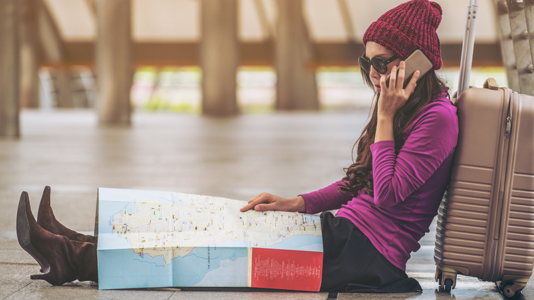 traveler with map and suitcase