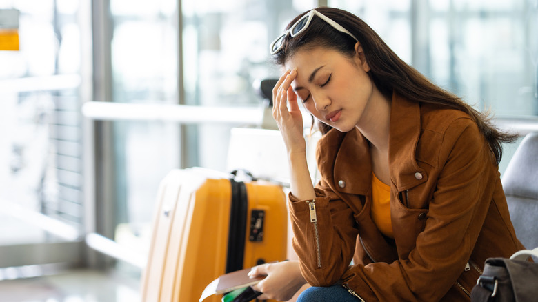 a tired woman waiting at the airport