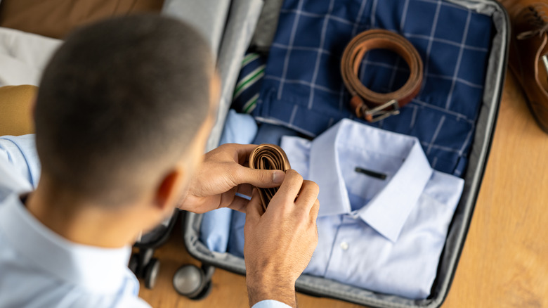 Man packing suitcase