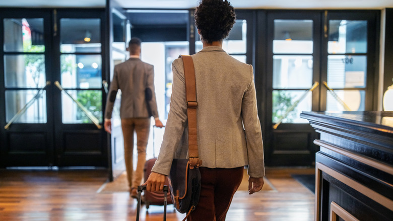 Travelers exiting a hotel