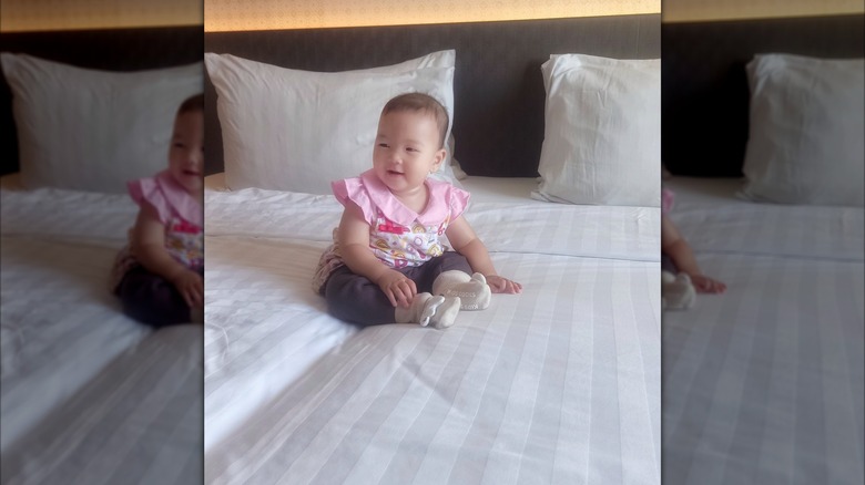 A baby in a hotel room