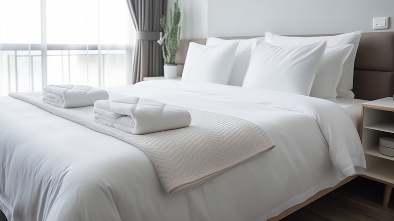 Clean towels on a hotel bed