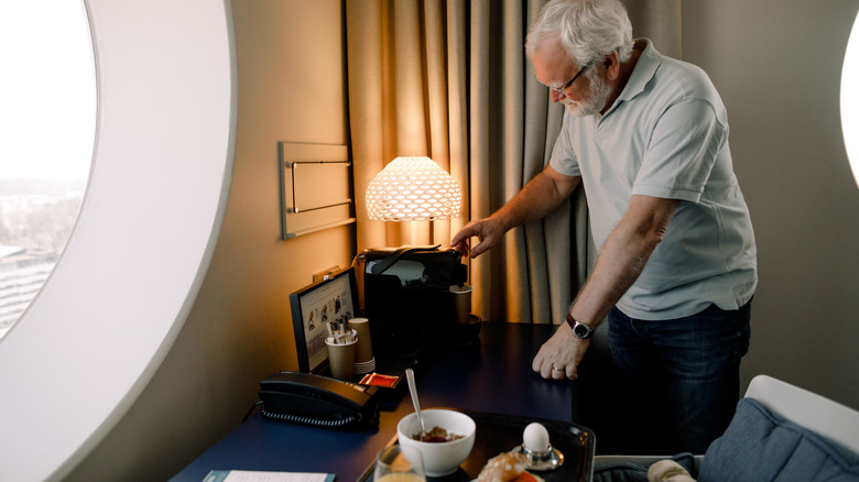 A man preparing breakfast in his hotel room