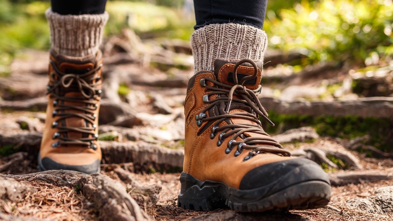 Close up of someone's hiking boots on a trail as they walk