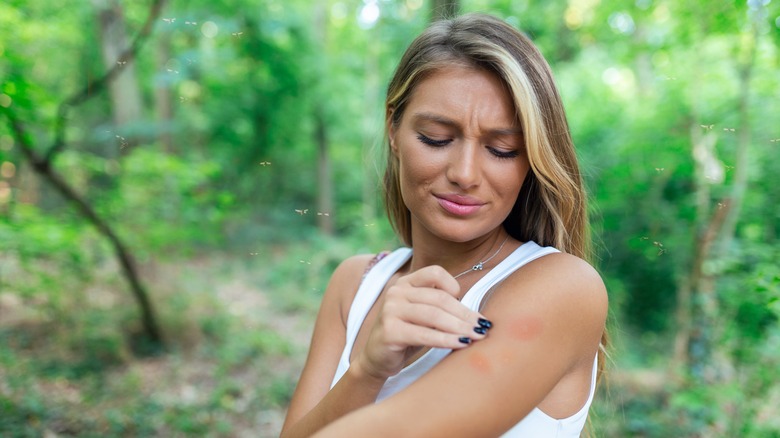 Woman grimacing at bug bite