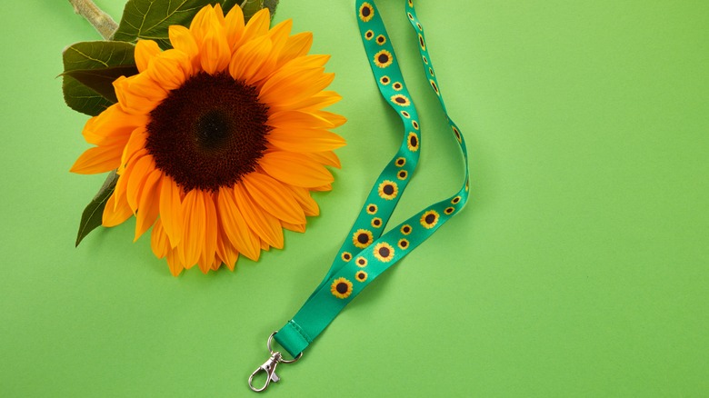 Sunflower lanyard next to a sunflower