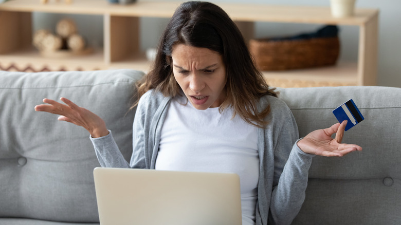 Woman looking angrily at laptop screen