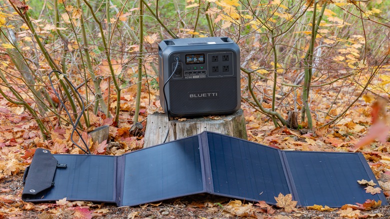 Bluetti solar system set up outdoors on fall leaves.
