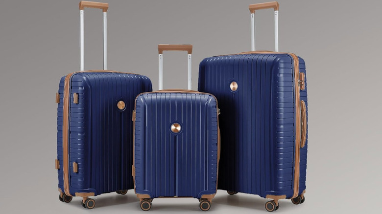 Three pieces of the Joyway 5-Piece Luggage Set in blue.