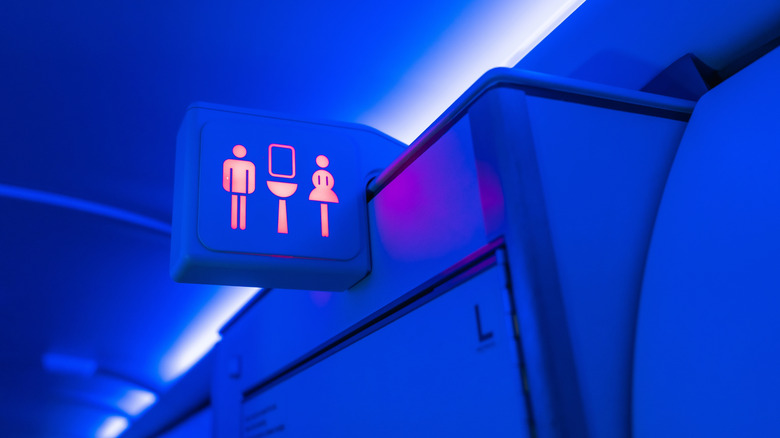 Airplane lavatory light lit pink and blue light around