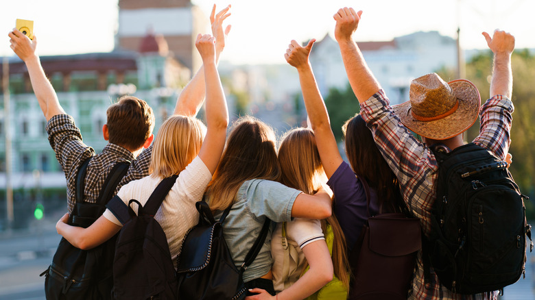 People with arms around each other, cheering