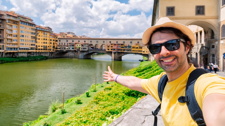 Young male traveller taking selfie at the Ponte Vecchio