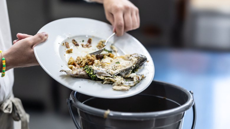 Person throwing away leftovers