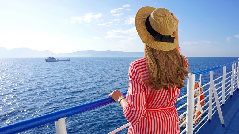 Female passenger on cruise ship looking out at the sea