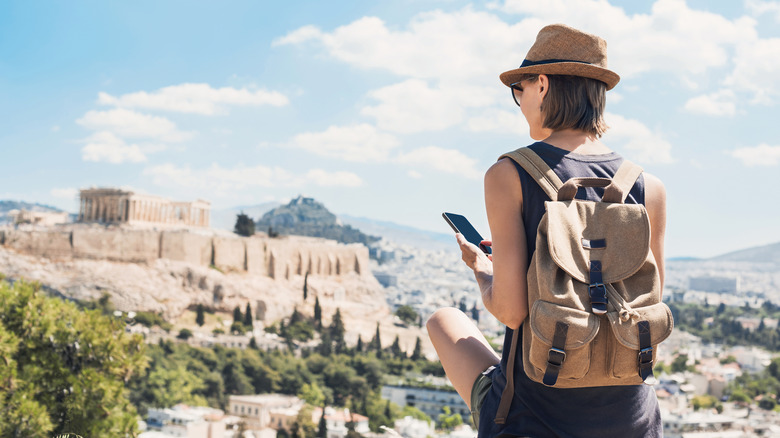 Female traveler holding cell phone