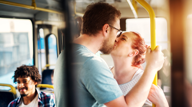 Couple kissing on a public bus