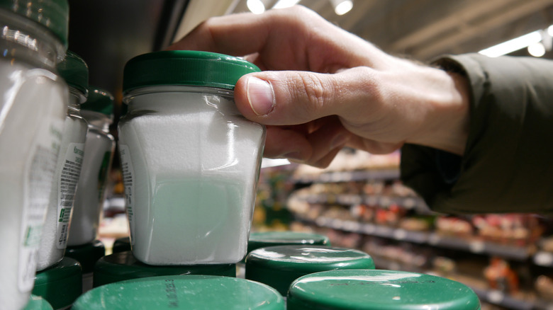 hand grabbing salt from shelf