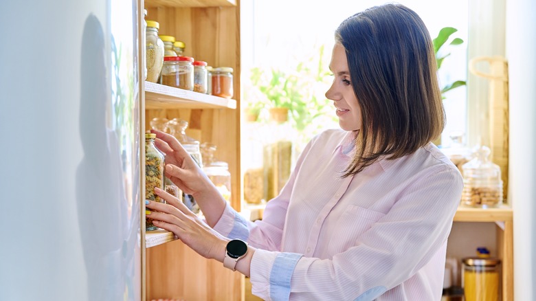 Woman checking pantry